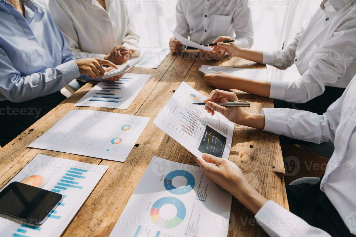 Financial analysts analyze business financial reports on a digital tablet planning investment project during a discussion at a meeting of corporate showing the results of their successful teamwork. photo