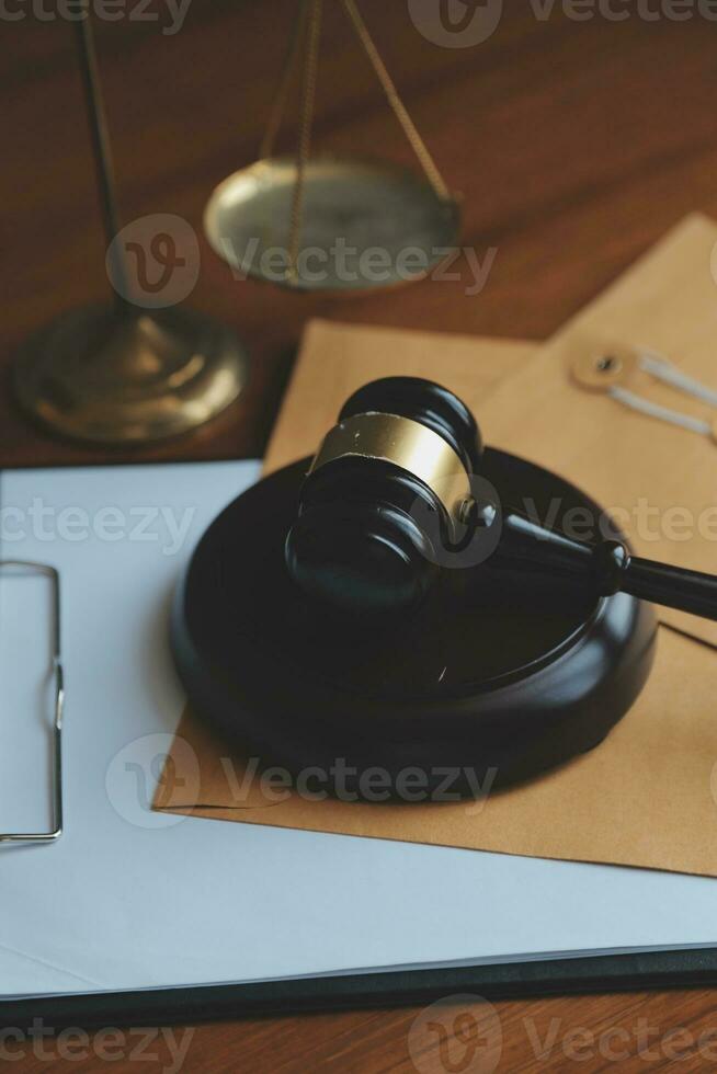 Business and lawyers discussing contract papers with brass scale on desk in office. Law, legal services, advice, justice and law concept picture with film grain effect photo