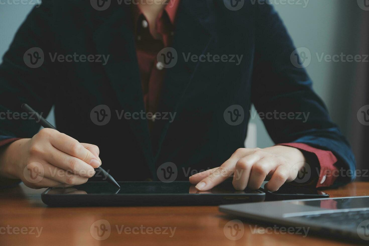 Asian Businesswoman Using laptop computer and working at office with calculator document on desk, doing planning analyzing the financial report, business plan investment, finance analysis concept. photo