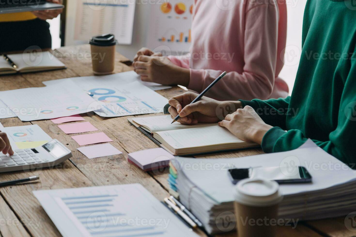 Financial analysts analyze business financial reports on a digital tablet planning investment project during a discussion at a meeting of corporate showing the results of their successful teamwork. photo