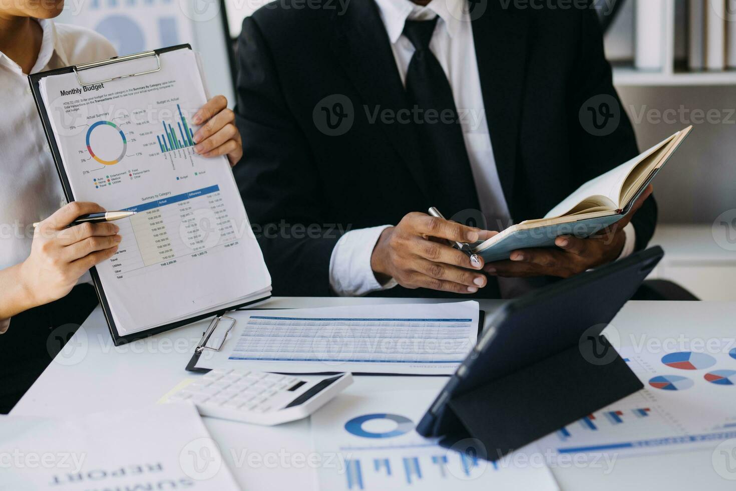 A couple is approaching a housing project to buy, and they are discussing details and advice with a salesperson in a housing project. Real estate trading ideas with couples. photo