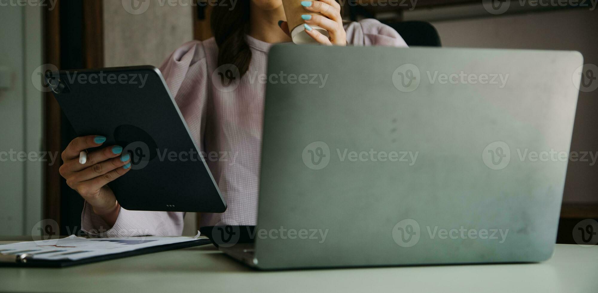 Young adult happy smiling Hispanic Asian student wearing headphones talking on online chat meeting using laptop in university campus or at virtual office. College female student learning remotely. photo