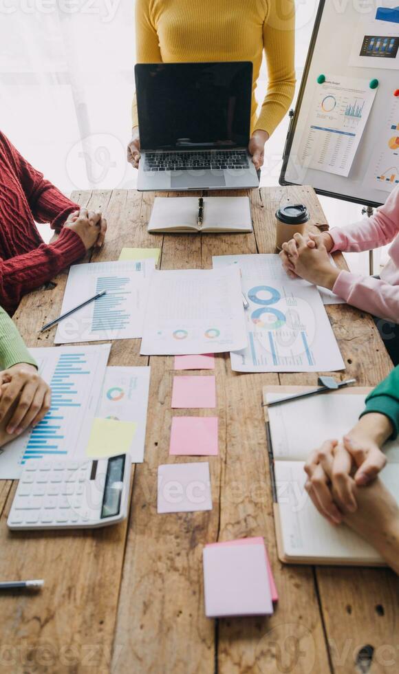 Financial analysts analyze business financial reports on a digital tablet planning investment project during a discussion at a meeting of corporate showing the results of their successful teamwork. photo