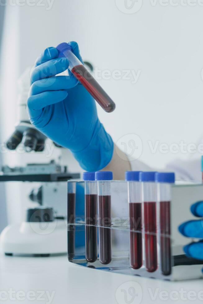 Medical Development Laboratory Caucasian Female Scientist Looking Under Microscope, Analyzes Petri Dish Sample. Specialists Working on Medicine, Biotechnology Research in Advanced Pharma Lab photo