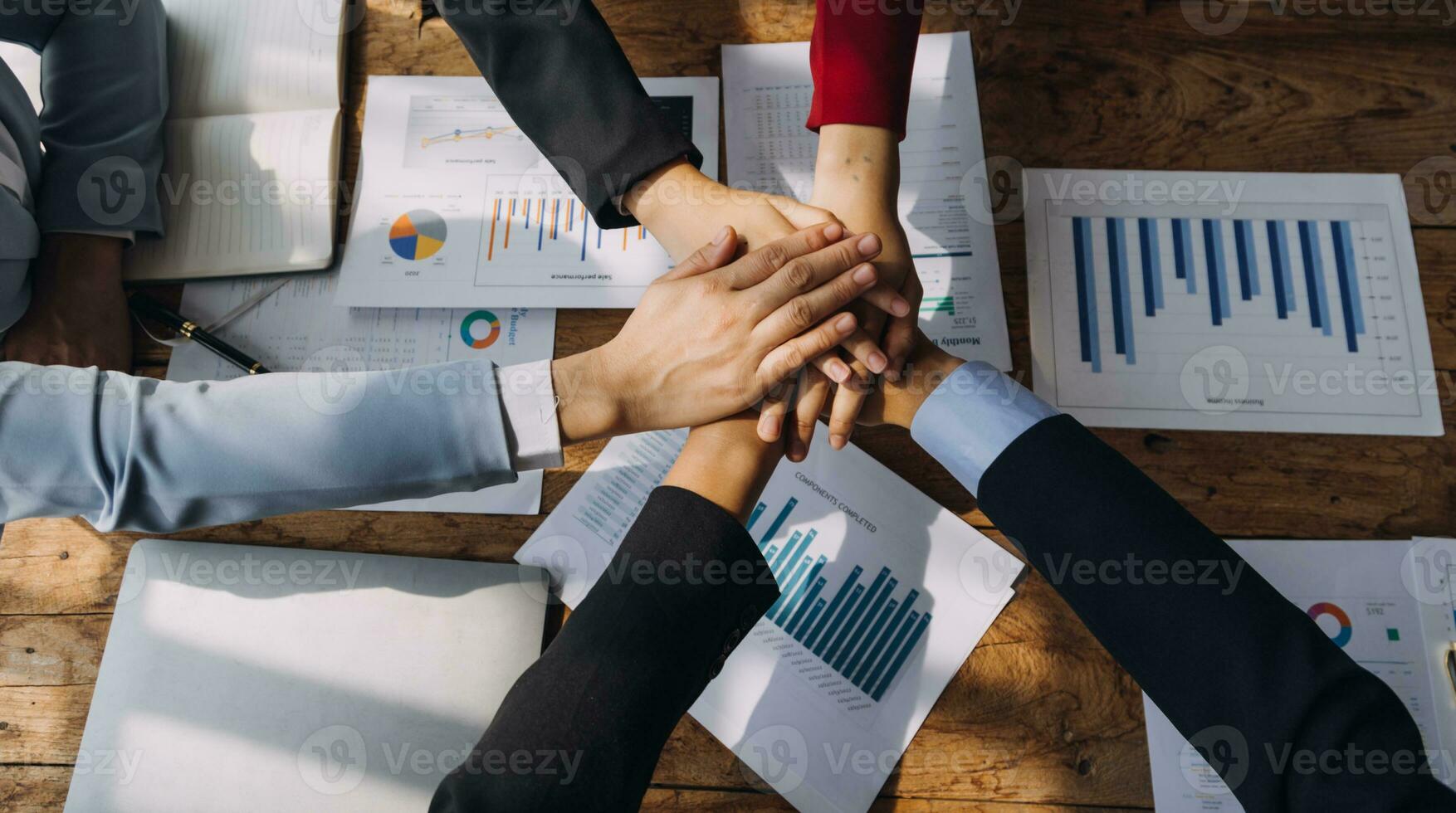 Financial analysts analyze business financial reports on a digital tablet planning investment project during a discussion at a meeting of corporate showing the results of their successful teamwork. photo