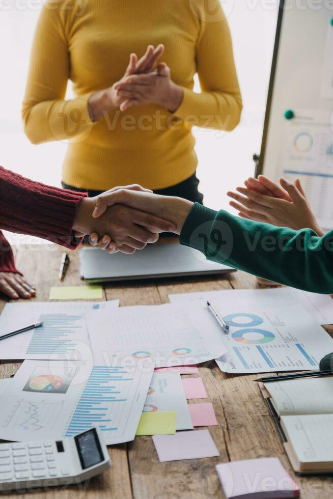 Financial analysts analyze business financial reports on a digital tablet planning investment project during a discussion at a meeting of corporate showing the results of their successful teamwork. photo