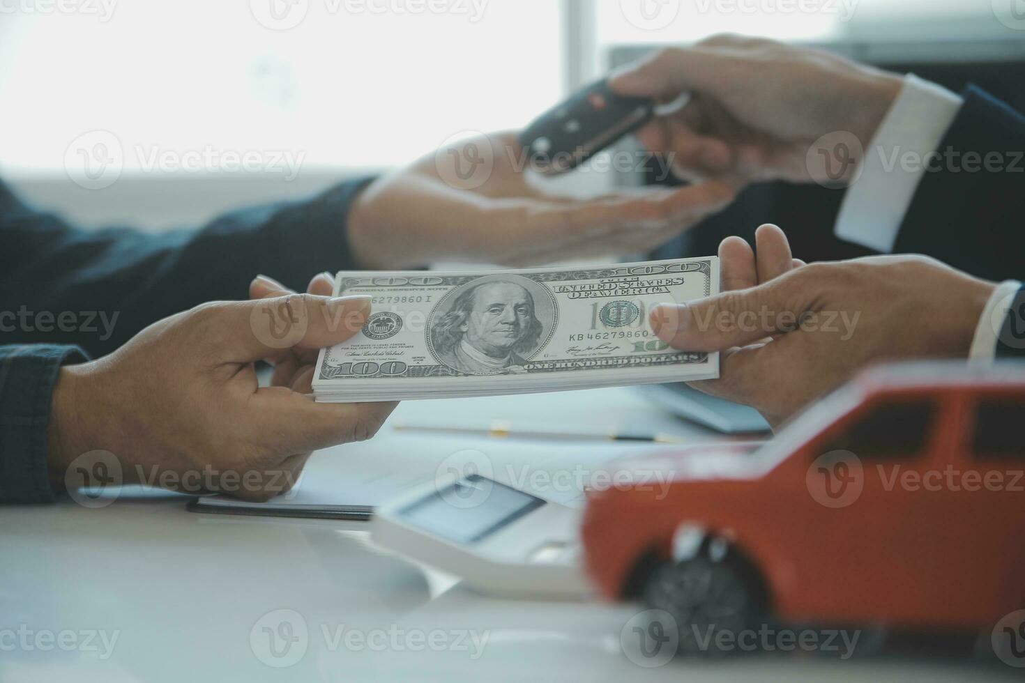 Closeup asian male people car salesman or sales manager offers to sell a car and explains and reads the terms of signing a car contract and insurance. photo