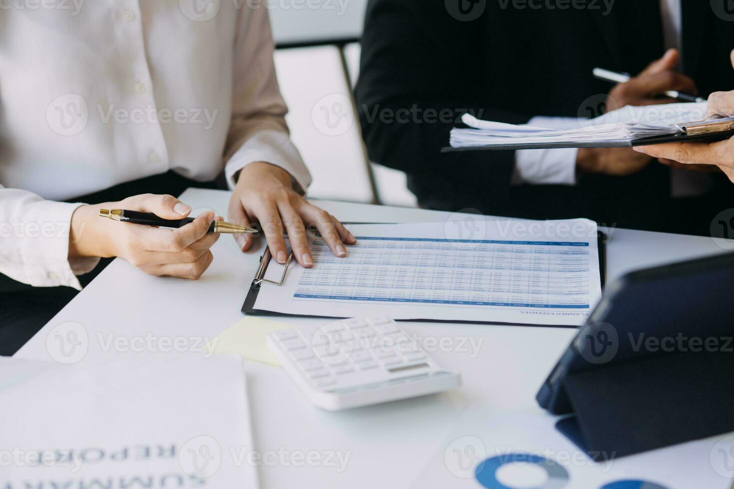 A couple is approaching a housing project to buy, and they are discussing details and advice with a salesperson in a housing project. Real estate trading ideas with couples. photo