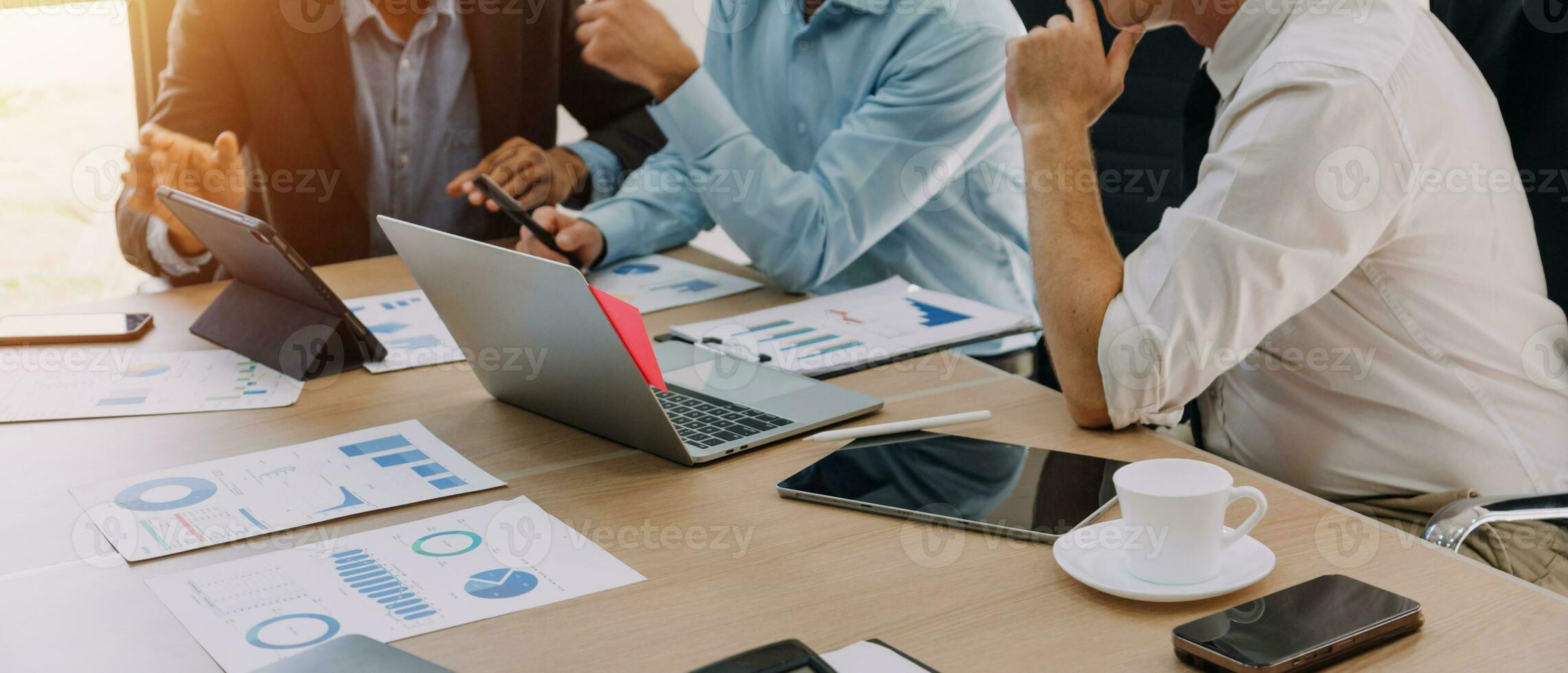 Financial analysts analyze business financial reports on a digital tablet planning investment project during a discussion at a meeting of corporate showing the results of their successful teamwork. photo