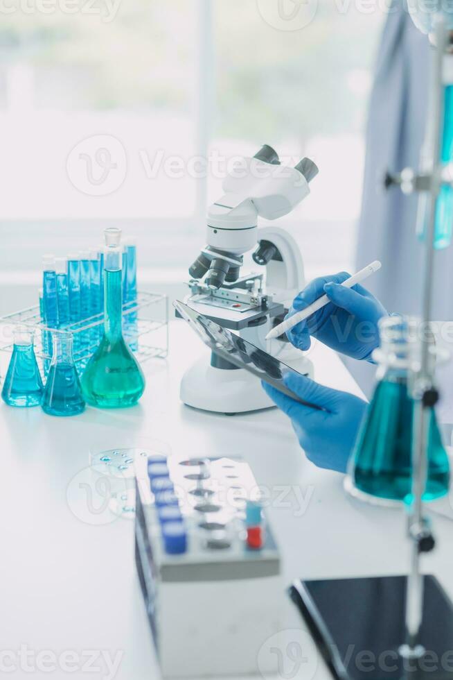 Medical Development Laboratory Caucasian Female Scientist Looking Under Microscope, Analyzes Petri Dish Sample. Specialists Working on Medicine, Biotechnology Research in Advanced Pharma Lab photo