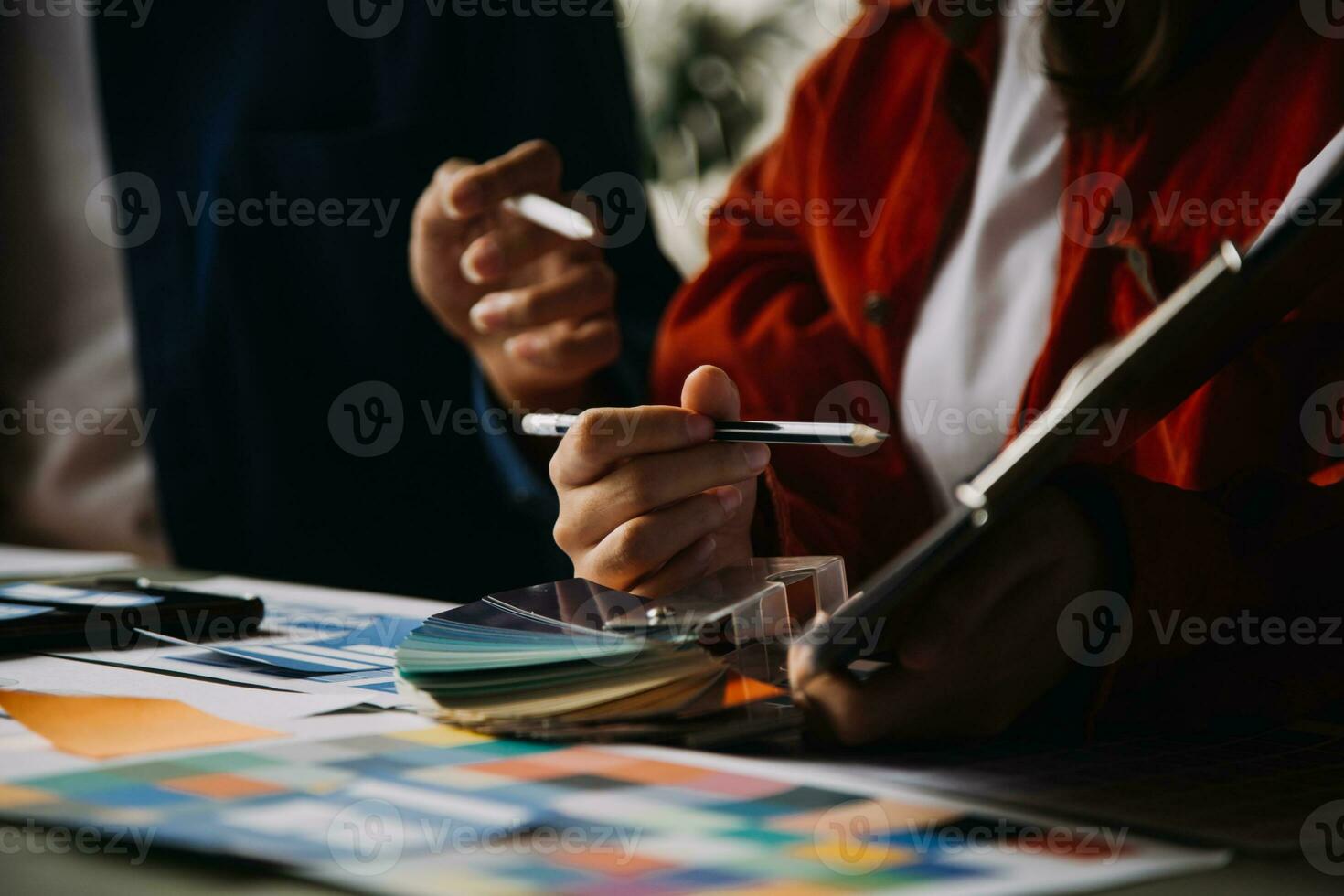 Close up ux developer and ui designer brainstorming about mobile app interface wireframe design on table with customer breif and color code at modern office.Creative digital development agency photo