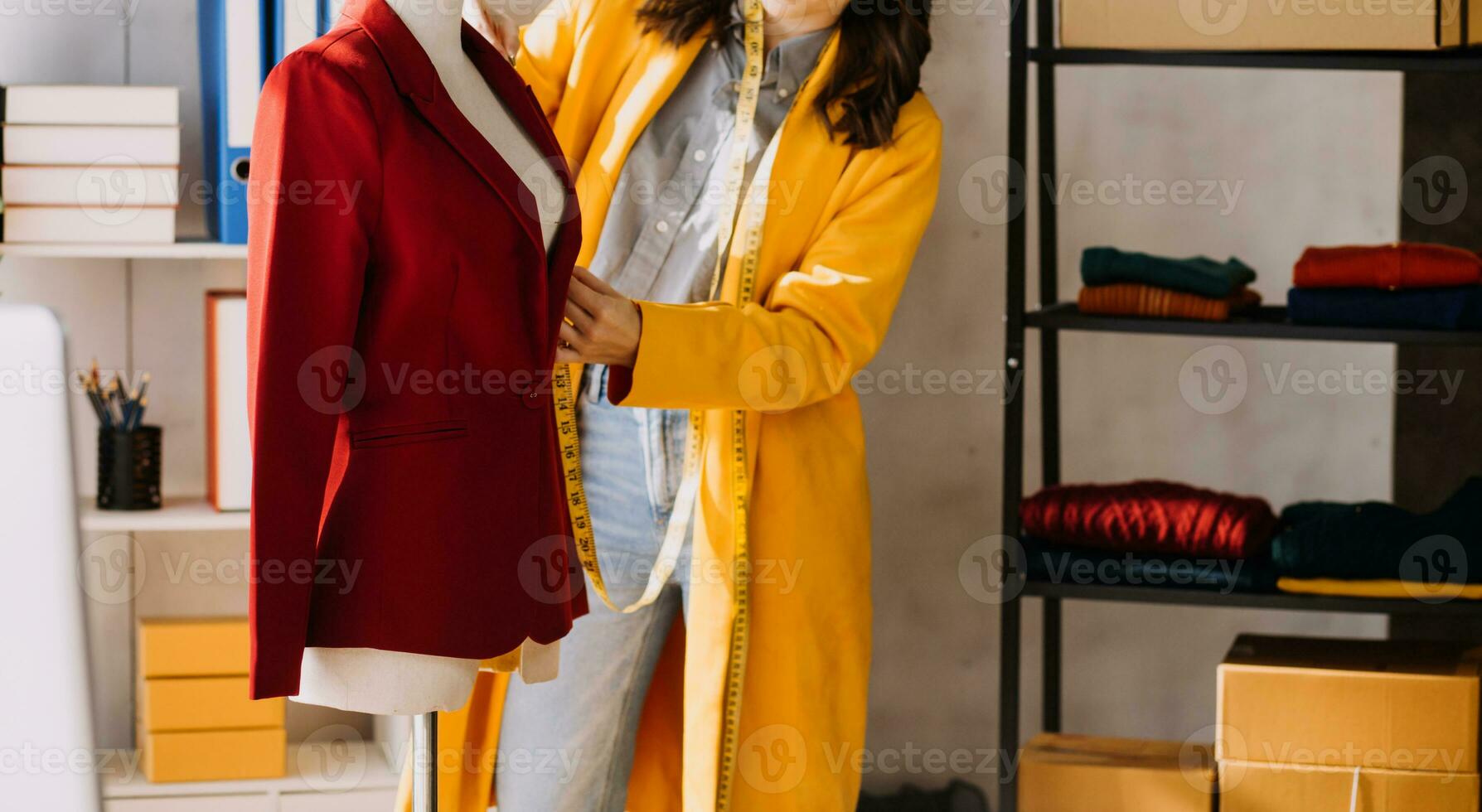 Fashion designer l young asian woman working using laptop, tablet and smiling while standing in workshop Responding on business photo