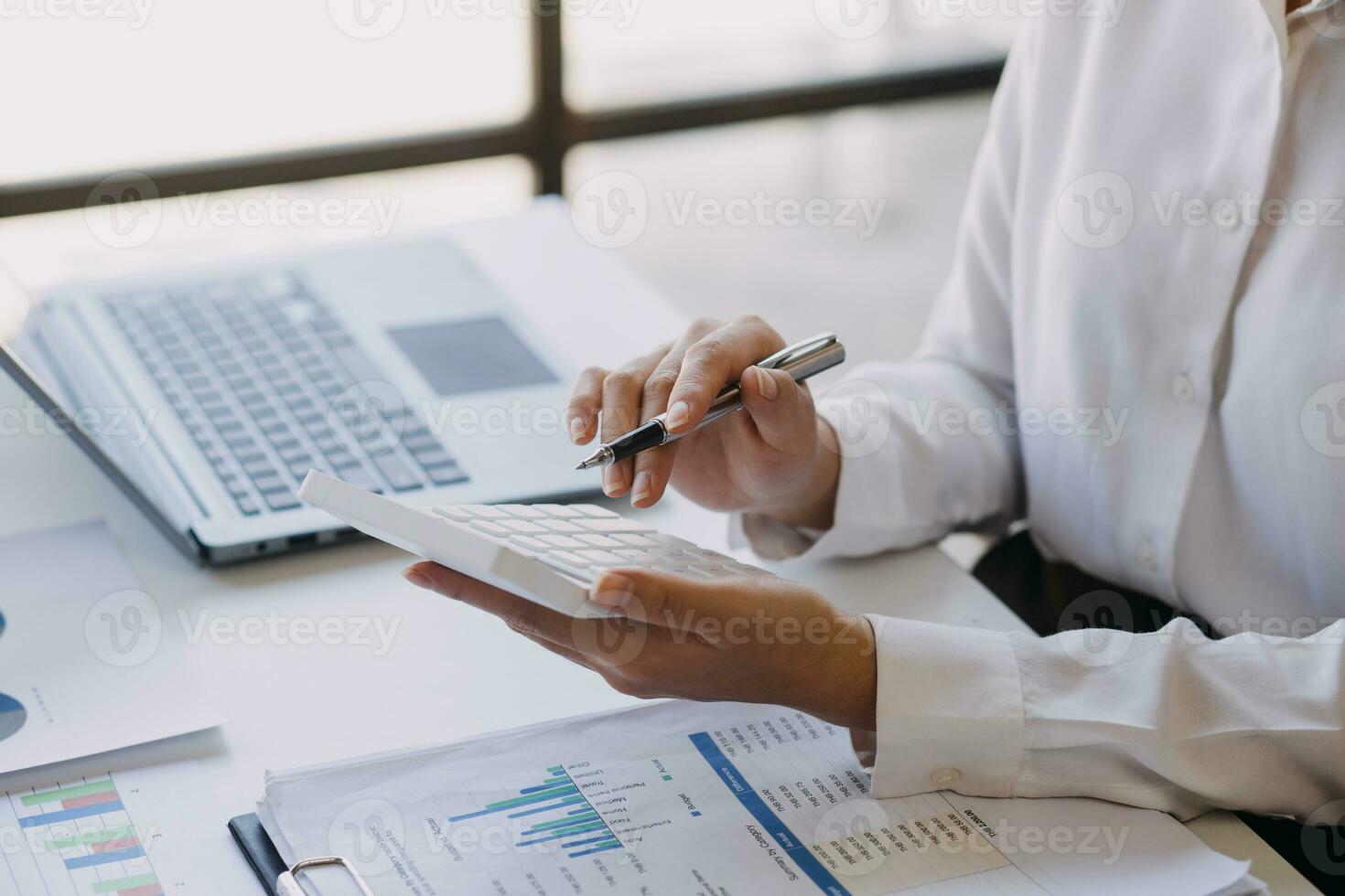 A couple is approaching a housing project to buy, and they are discussing details and advice with a salesperson in a housing project. Real estate trading ideas with couples. photo