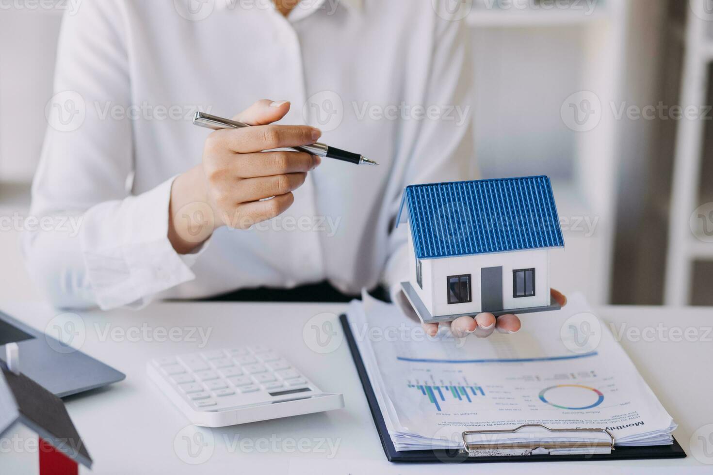 A couple is approaching a housing project to buy, and they are discussing details and advice with a salesperson in a housing project. Real estate trading ideas with couples. photo