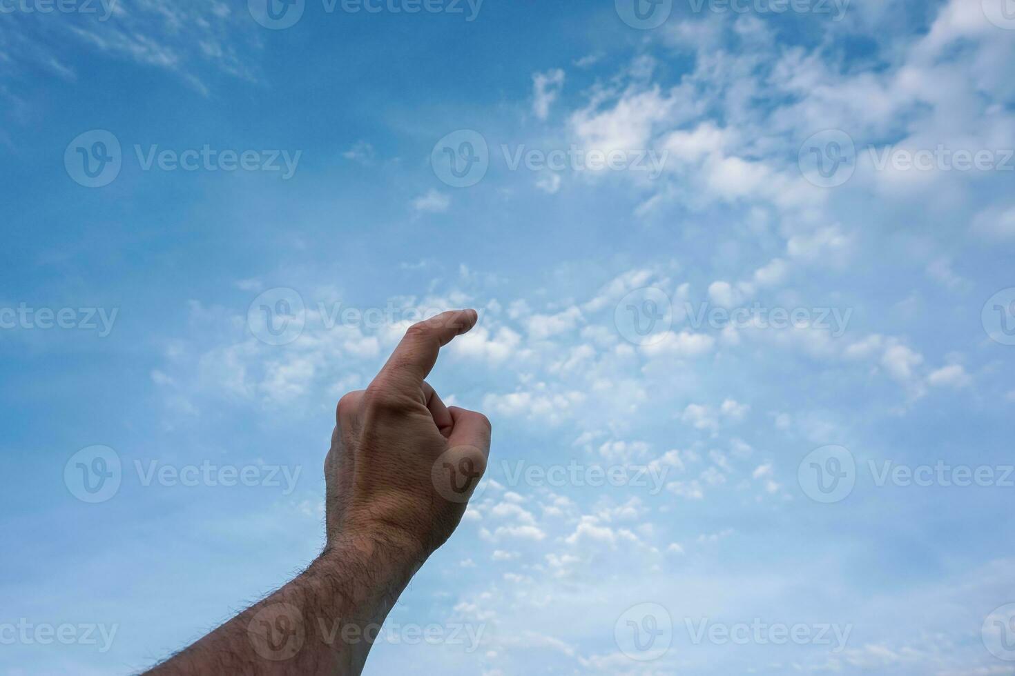 hand up gesturing in the blue sky, feelings and emotions photo