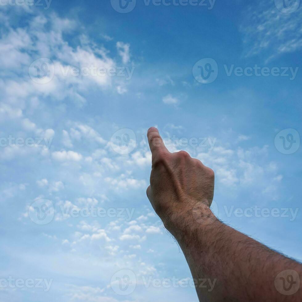 hand up gesturing in the blue sky, feelings and emotions photo