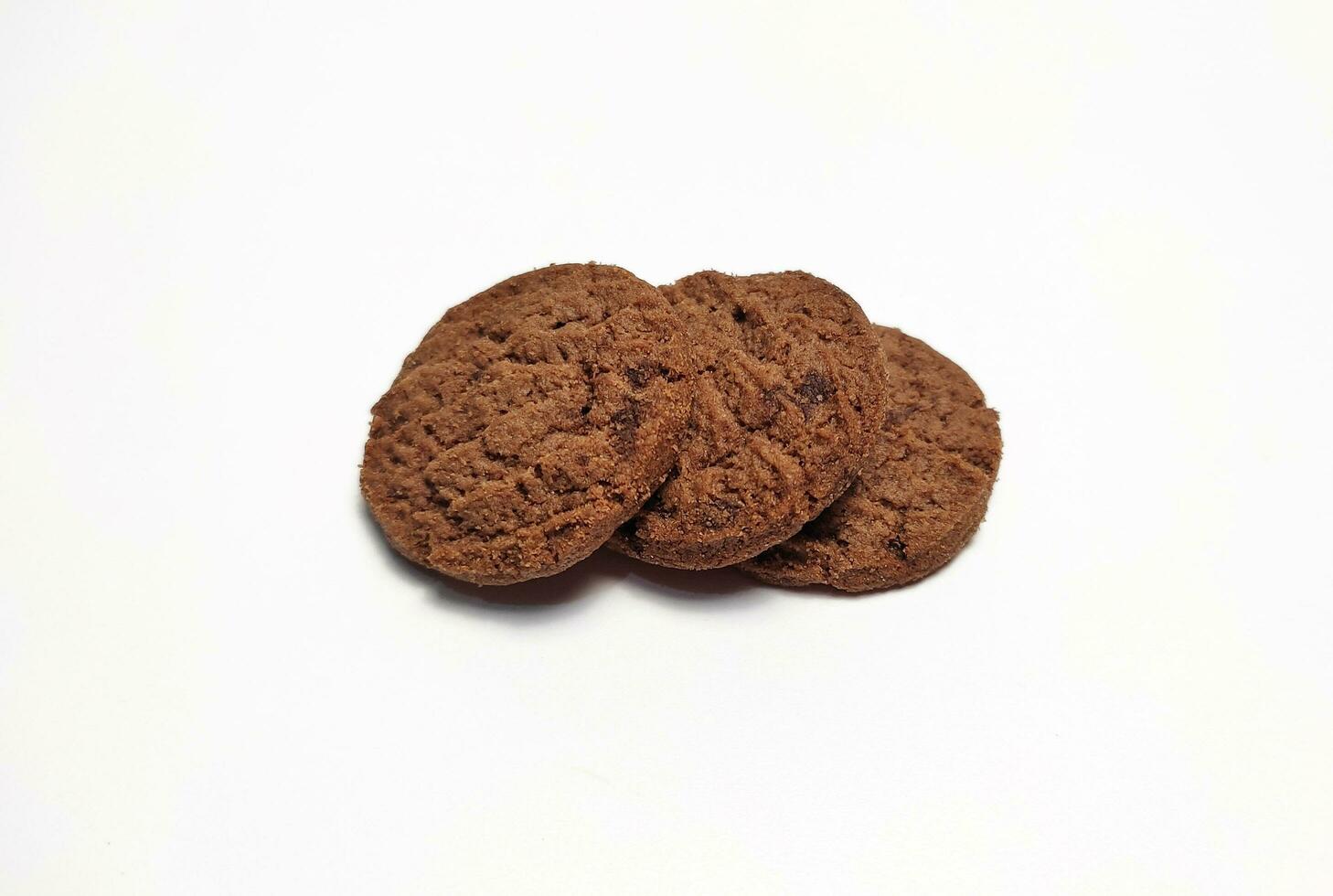 Several round shaped chocolate biscuits isolated on a white background. photo