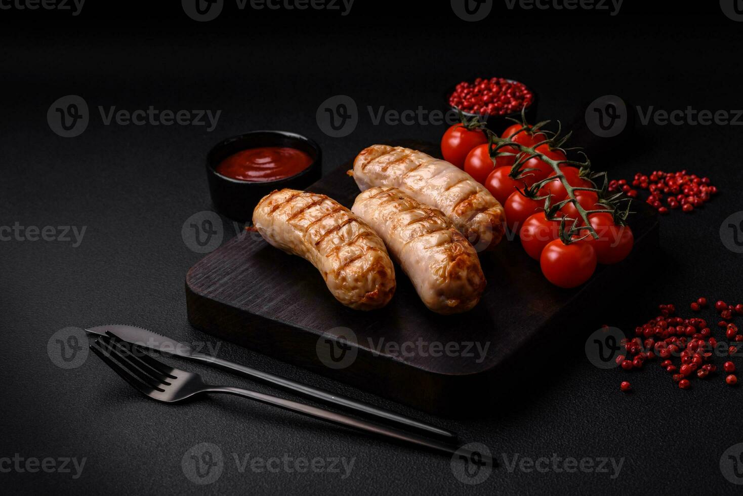 Delicious grilled sausages from chicken or pork meat with salt, spices and herbs photo