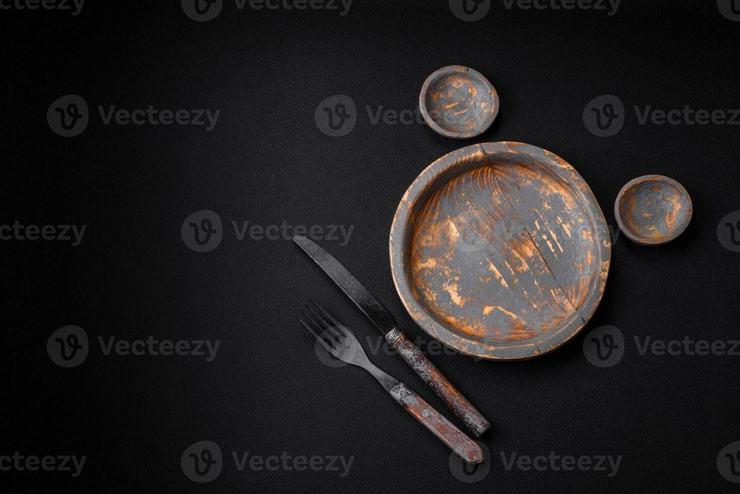 Empty wooden plate, knife, fork and cutting board photo