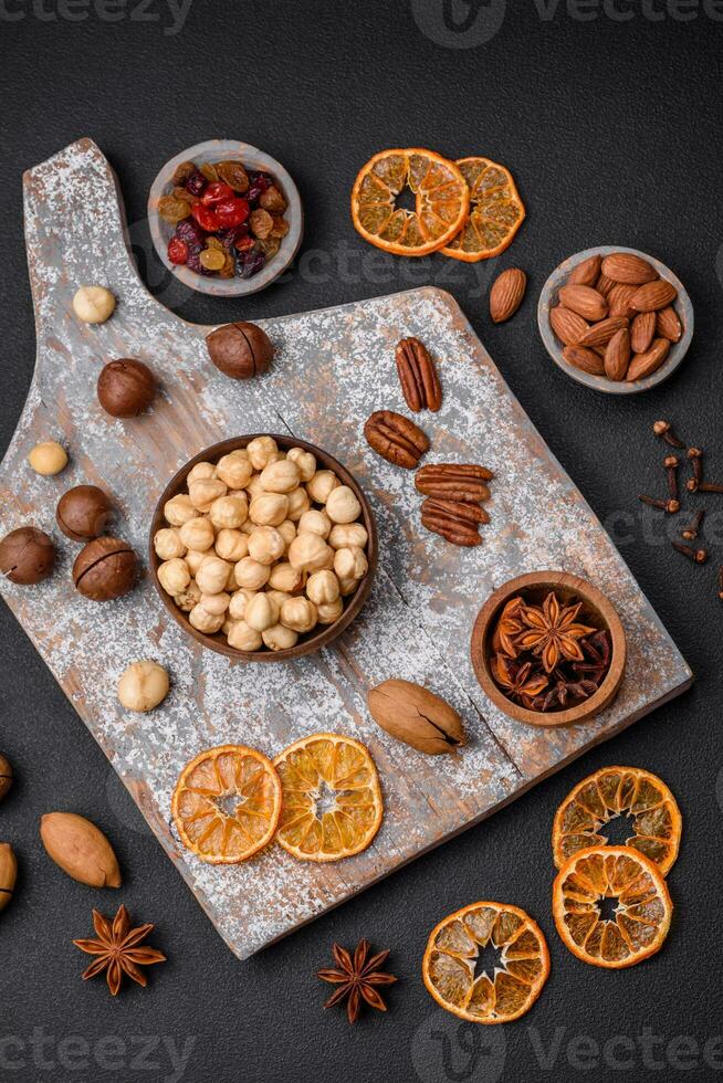 Mix of roasted macadamia nuts, cashews, pecans, almonds, raisins and dry berries photo