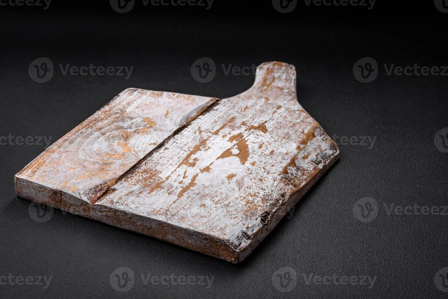 Empty wooden cutting board with cracks and scuffs photo