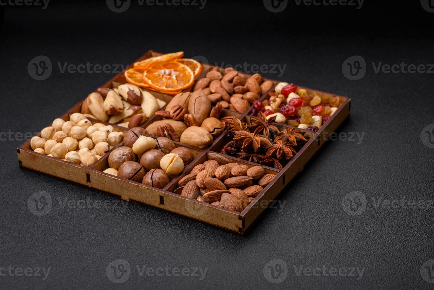 Mix of roasted macadamia nuts, cashews, pecans, almonds, raisins and dry berries photo