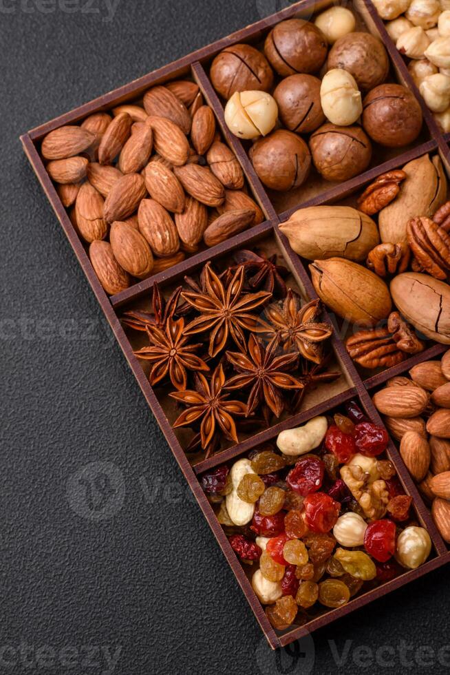 Mix of roasted macadamia nuts, cashews, pecans, almonds, raisins and dry berries photo