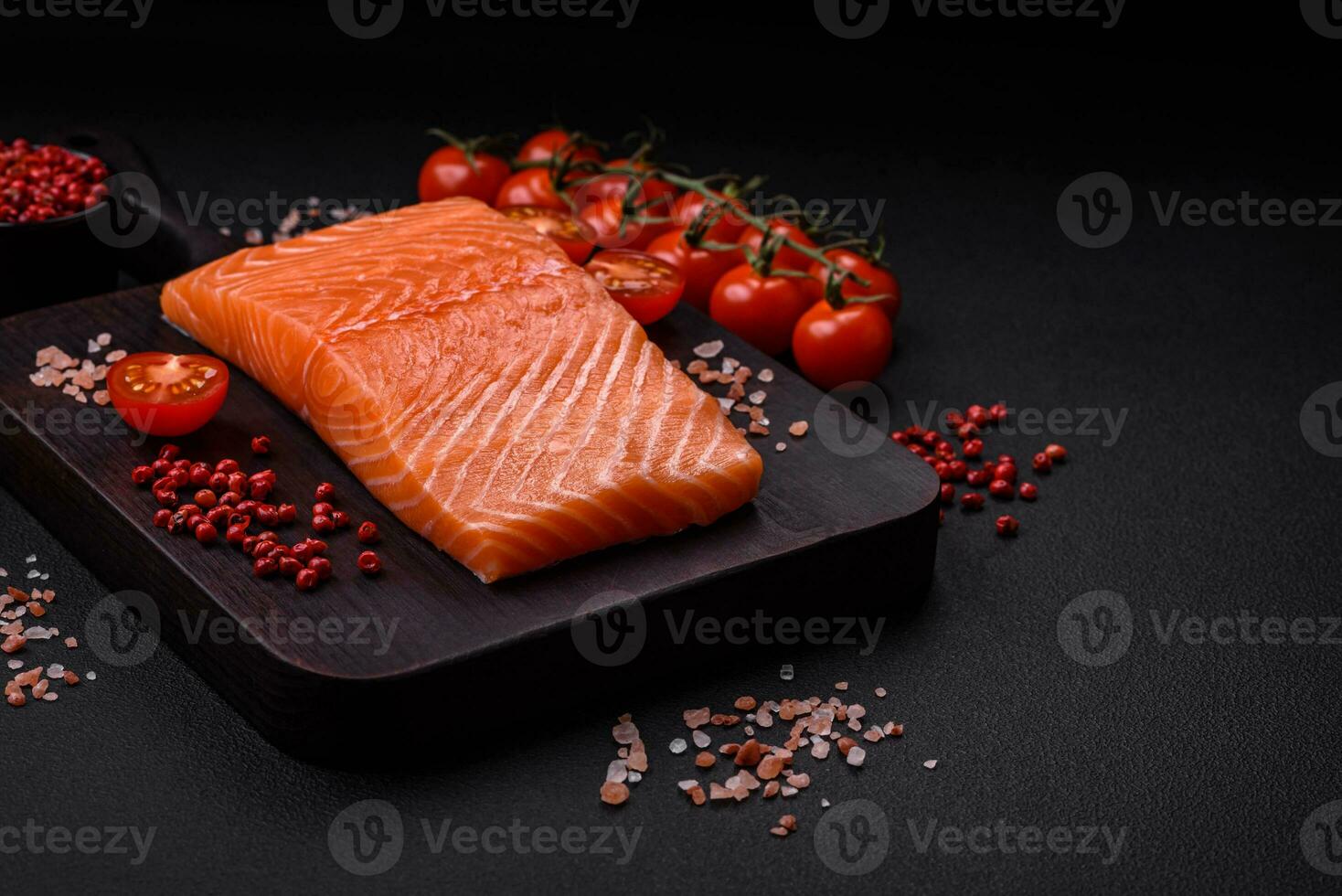 Fresh raw salmon red fish fillet with salt and spices photo