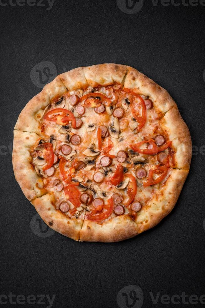 Bavarian pizza with smoked sausages, tomatoes, cheese, salt and spices photo