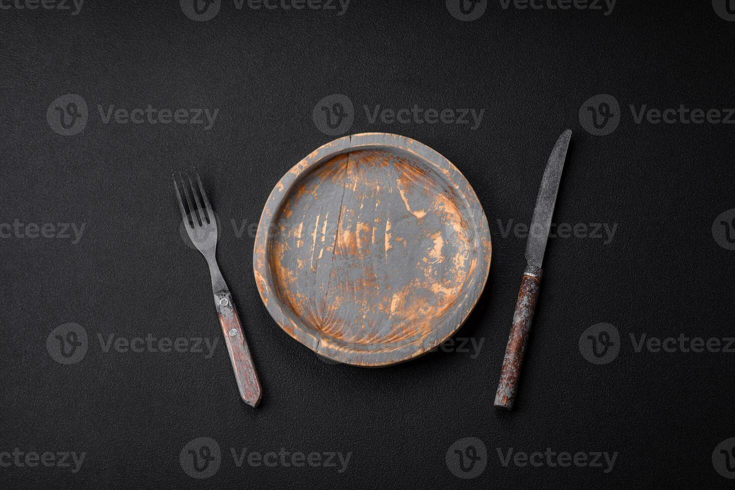 Empty wooden plate, knife, fork and cutting board photo