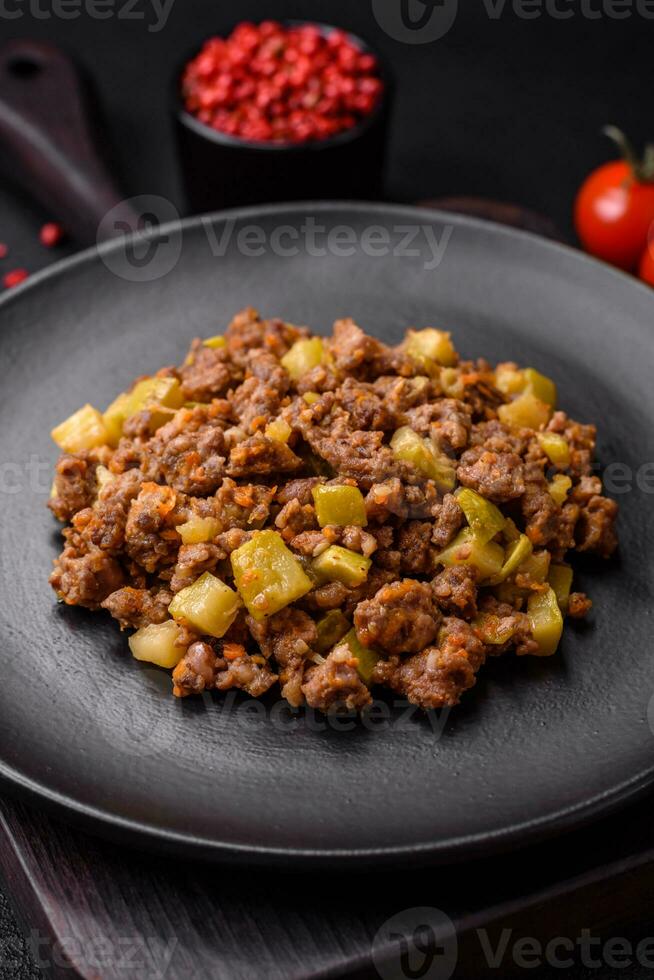 Tasty dish consisting of zucchini, beef meat, mushrooms, onions and garlic photo