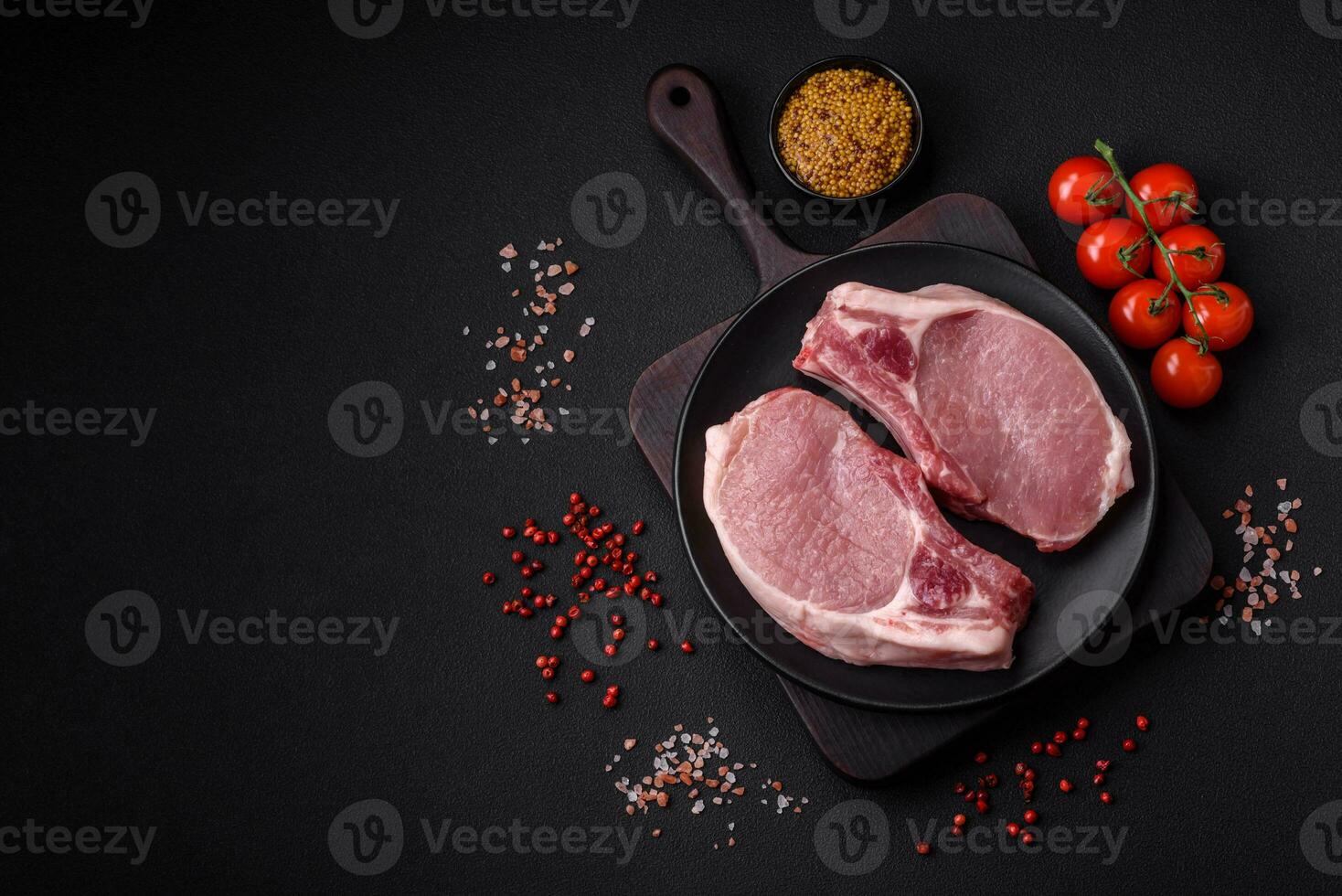 Raw pork on the bone or rib sliced with salt, spices and herbs photo