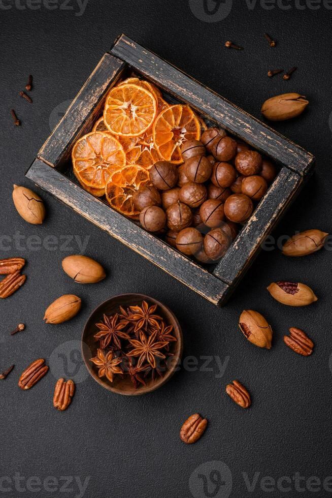Roasted pecans and macadamia nuts, dried tangerine, dried berries photo