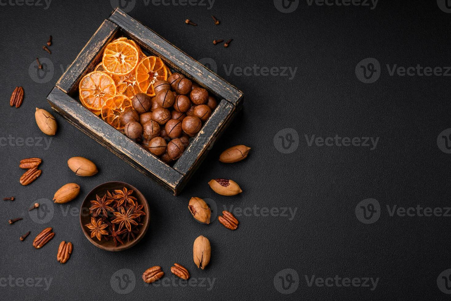 Roasted pecans and macadamia nuts, dried tangerine, dried berries photo