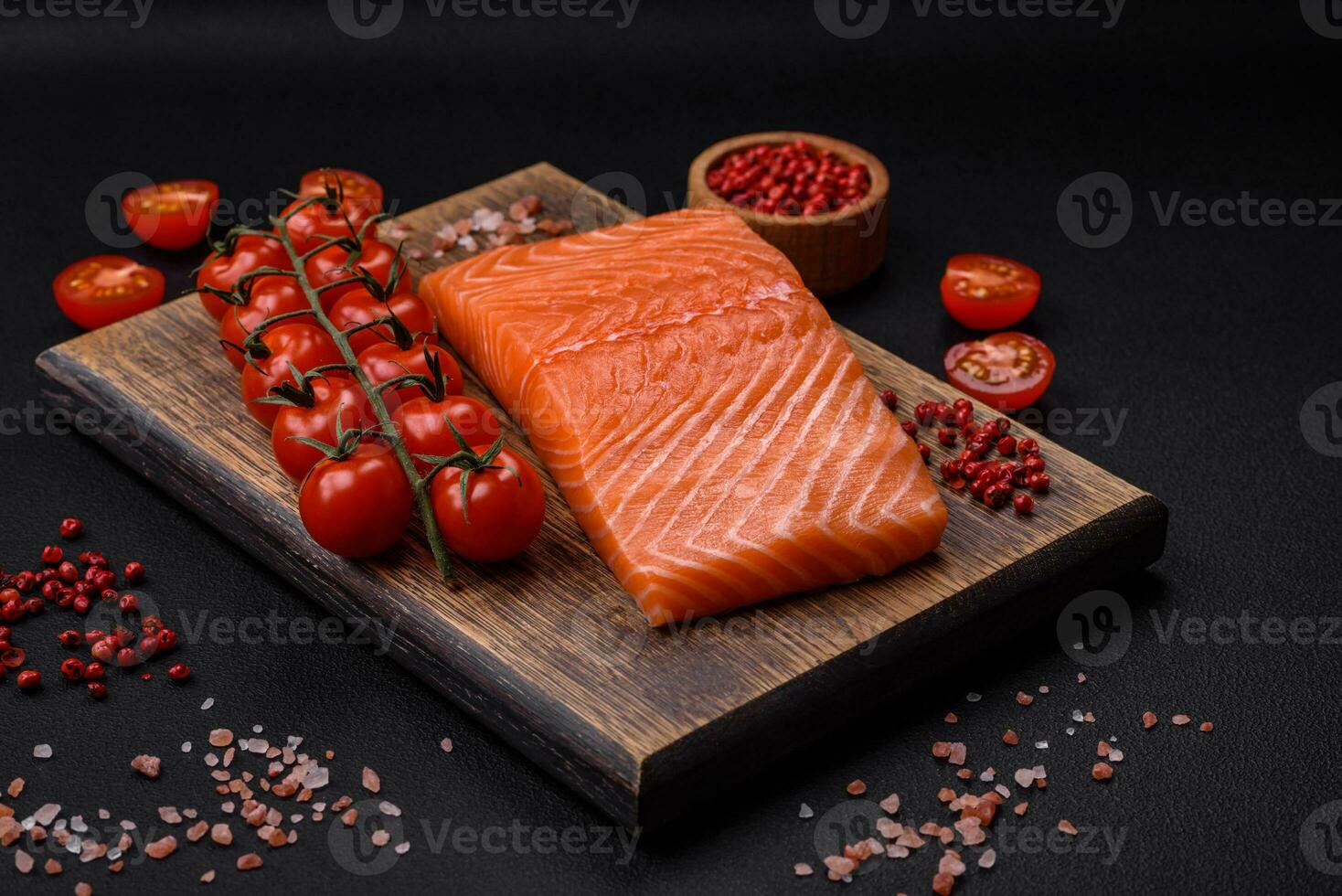 Fresh raw salmon red fish fillet with salt and spices photo