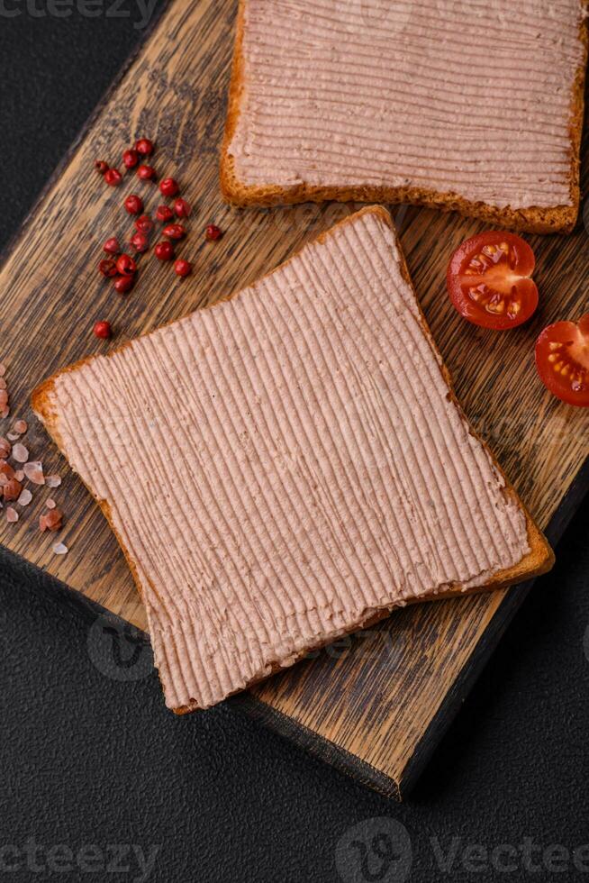 Delicious crispy toast with chicken or goose pate with salt and spices photo