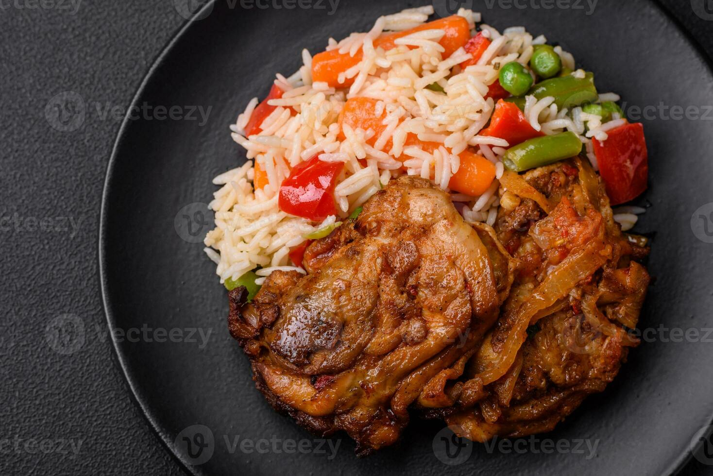 Delicious boiled rice with peppers, peas, asparagus beans and carrots and fried chicken photo