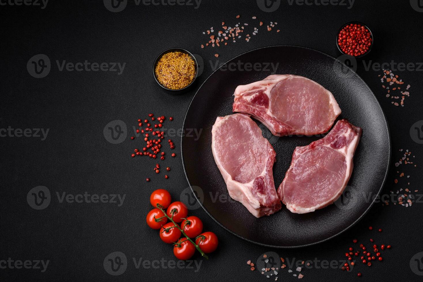 Raw pork on the bone or rib sliced with salt, spices and herbs photo