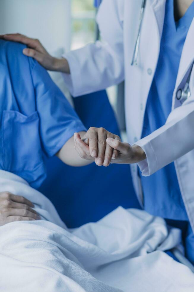 doctor check up after surgery. doctor touching patient hand and consoling. photo