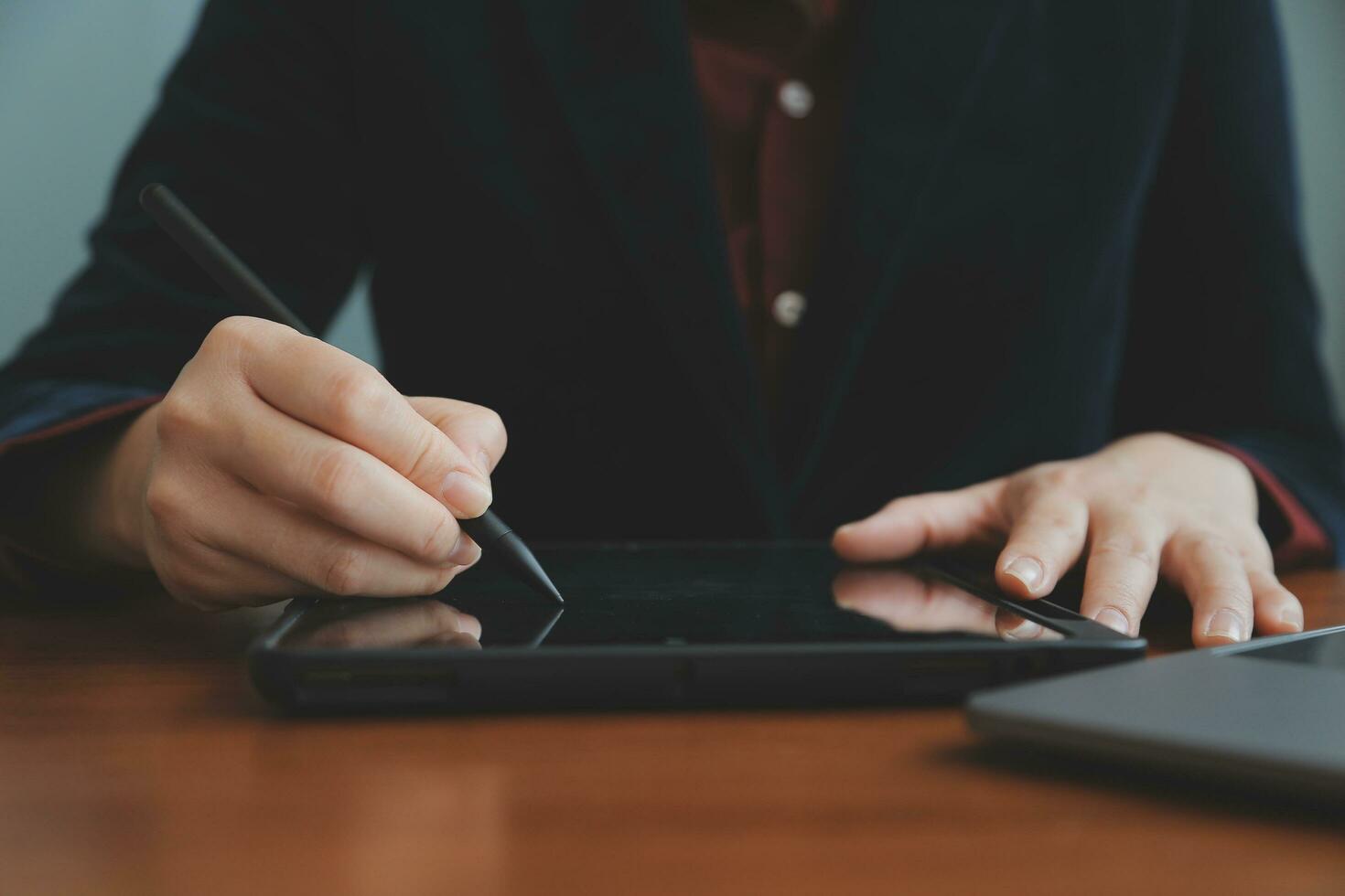 Asian Businesswoman Using laptop computer and working at office with calculator document on desk, doing planning analyzing the financial report, business plan investment, finance analysis concept. photo