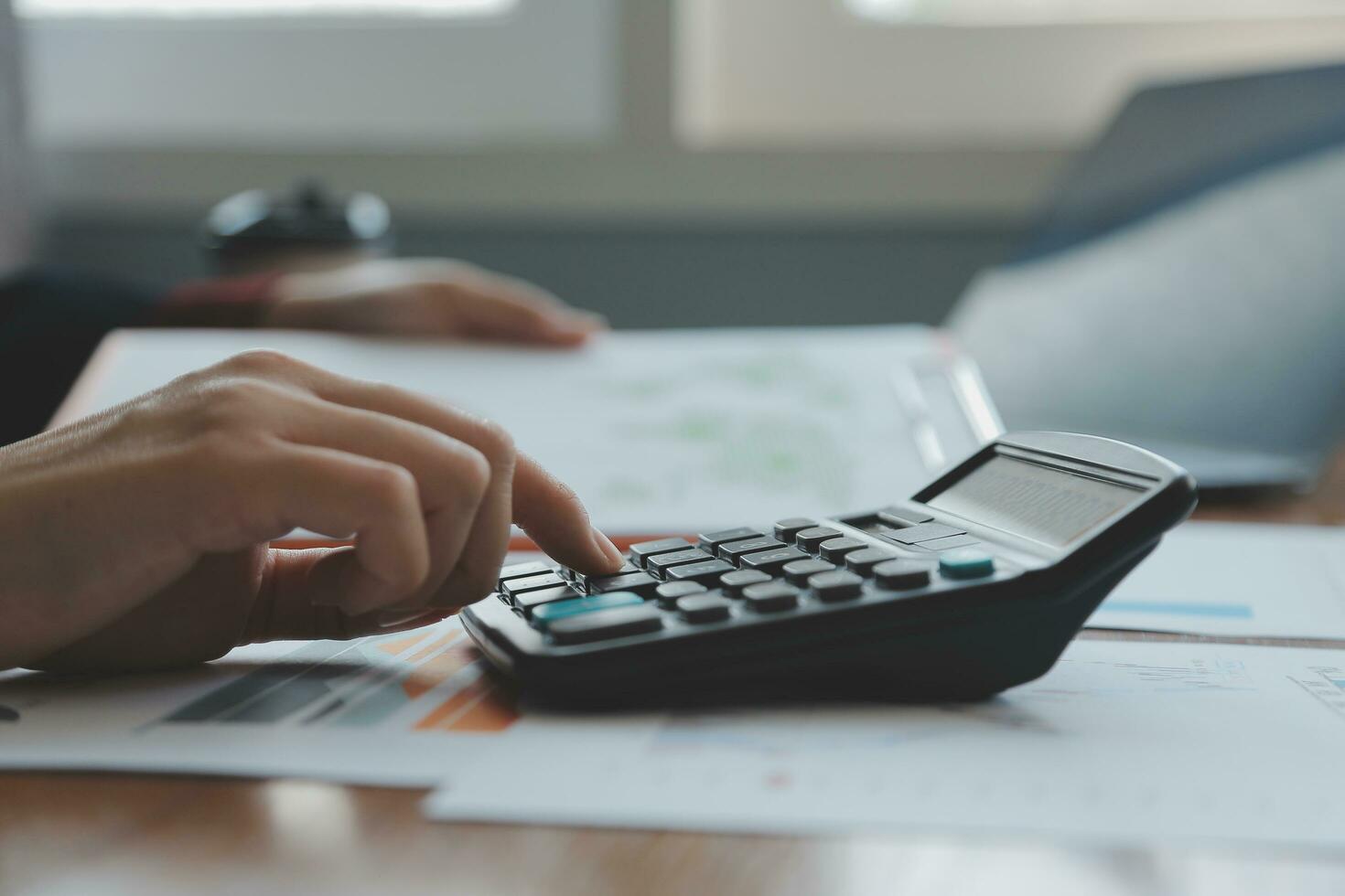 Group of confident business people point to graphs and charts to analyze market data, balance sheet, account, net profit to plan new sales strategies to increase production capacity. photo