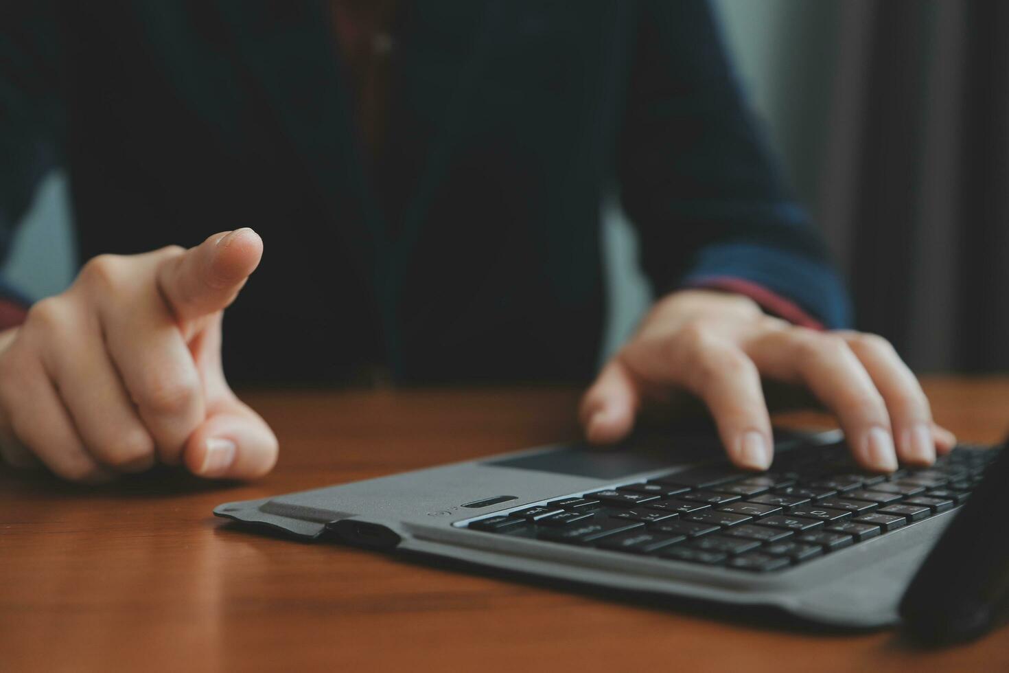 Asian Businesswoman Using laptop computer and working at office with calculator document on desk, doing planning analyzing the financial report, business plan investment, finance analysis concept. photo