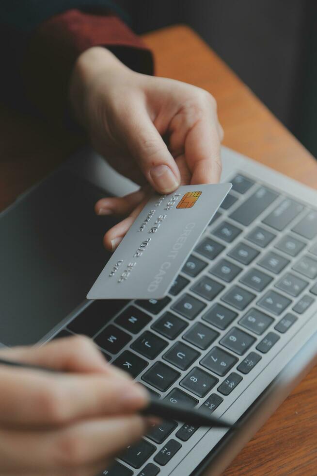 Women holding credit card and using smartphones at home.Online shopping, internet banking, store online, payment, spending money, e-commerce payment at the store, credit card, concept photo