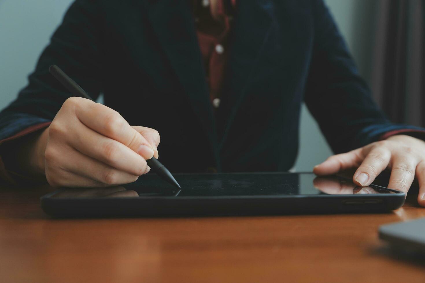 Asian Businesswoman Using laptop computer and working at office with calculator document on desk, doing planning analyzing the financial report, business plan investment, finance analysis concept. photo