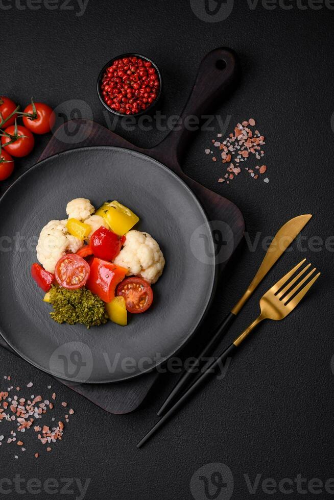 Delicious fresh salad of broccoli, cauliflower, sweet peppers and cherry tomatoes photo