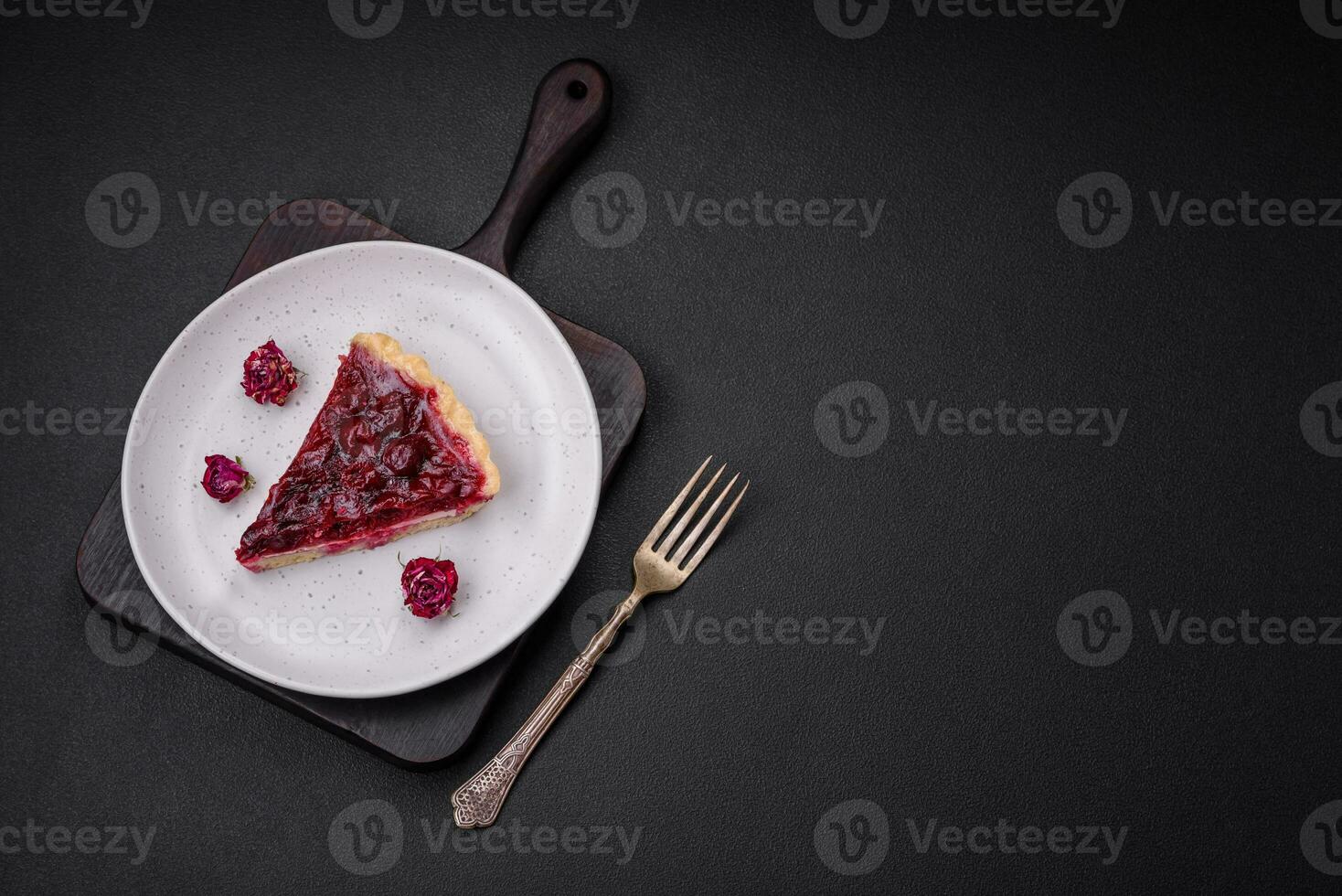 Delicious fragrant sweet pie with cherry berries on a ceramic plate photo