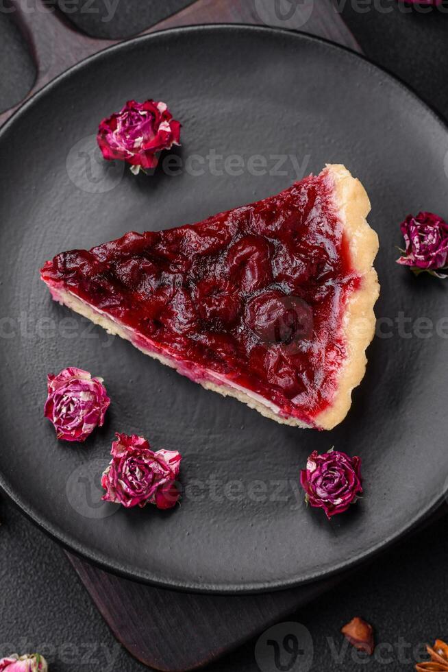 Delicious fragrant sweet pie with cherry berries on a ceramic plate photo