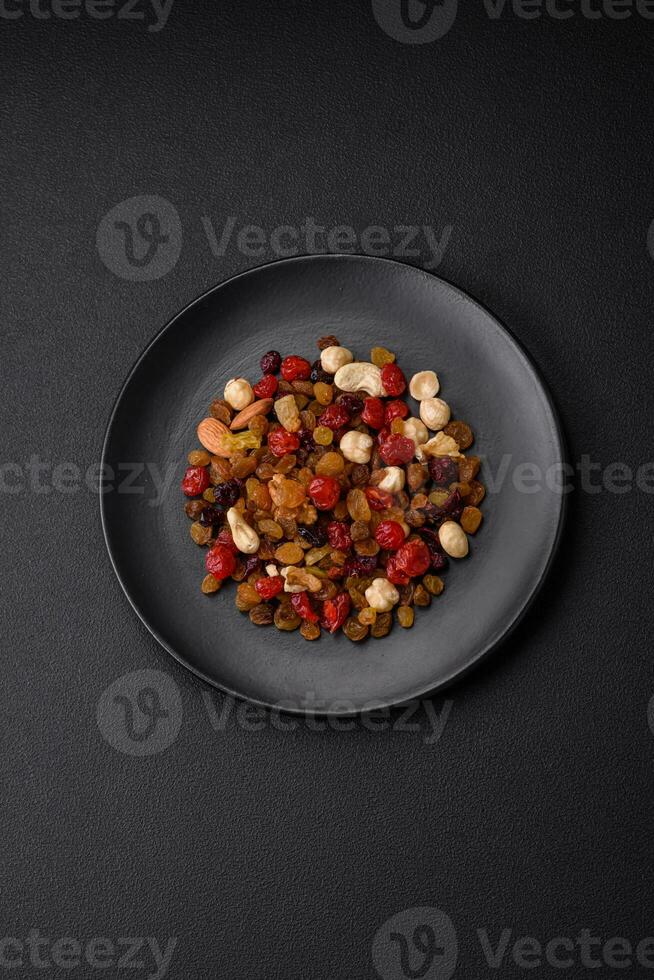 Mix of roasted cashews, hazelnuts and walnuts with dried cranberries and raisins photo