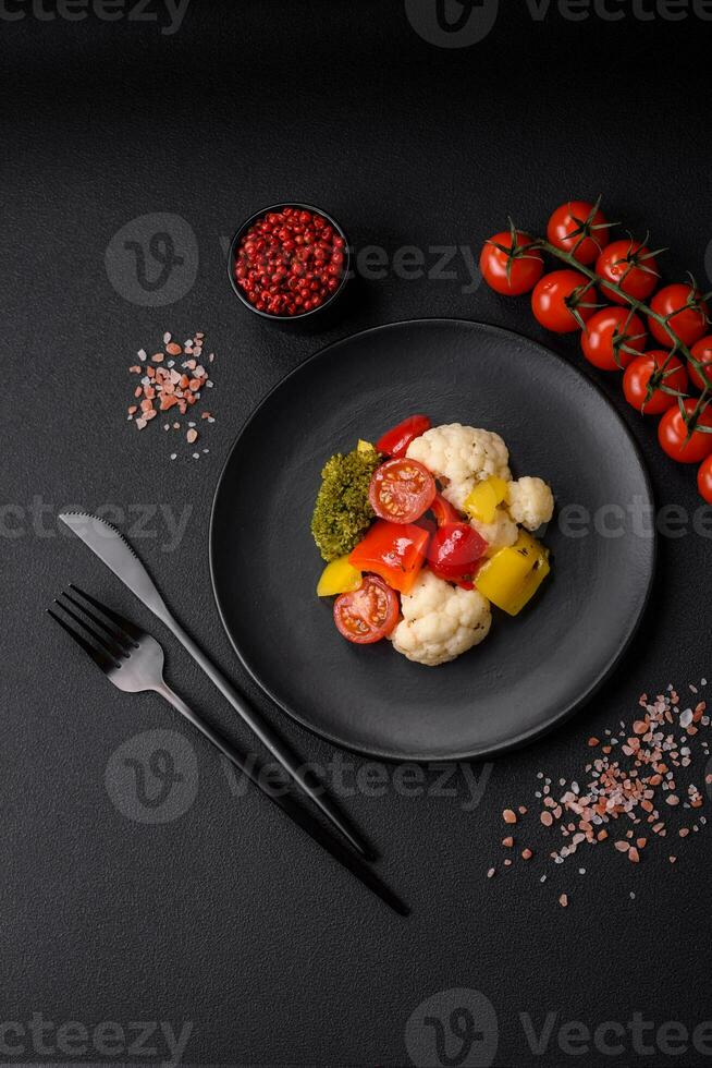 Delicious fresh salad of broccoli, cauliflower, sweet peppers and cherry tomatoes photo