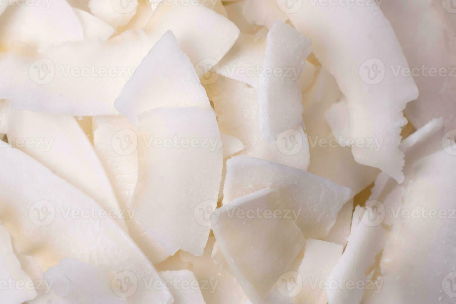 White dry coconut flakes in a wooden bowl prepared for making desserts photo